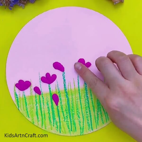 Pasting More Clay To Create Flowers- Artistic instruction for kids to make flowery scenery