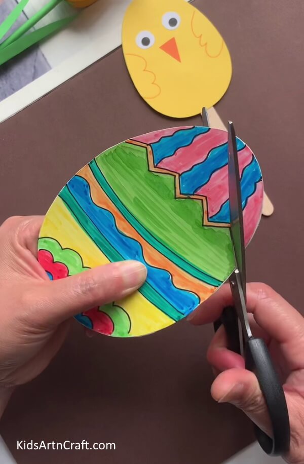 Cutting Out The White Eggs In A Zigzag Manner A tutorial to help children make Easter Eggs of many different colors.