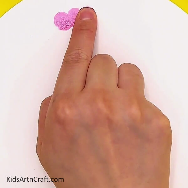 Making prints with your finger colour on white craft paper- A Detailed Guide to Help Kids Create Flower Fingerprint Art 