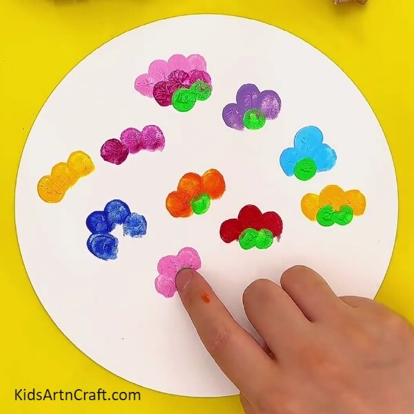 Making a finger print from green colour- Learn to Create Colorful Flower Fingerprint Paintings with Kids Easily 