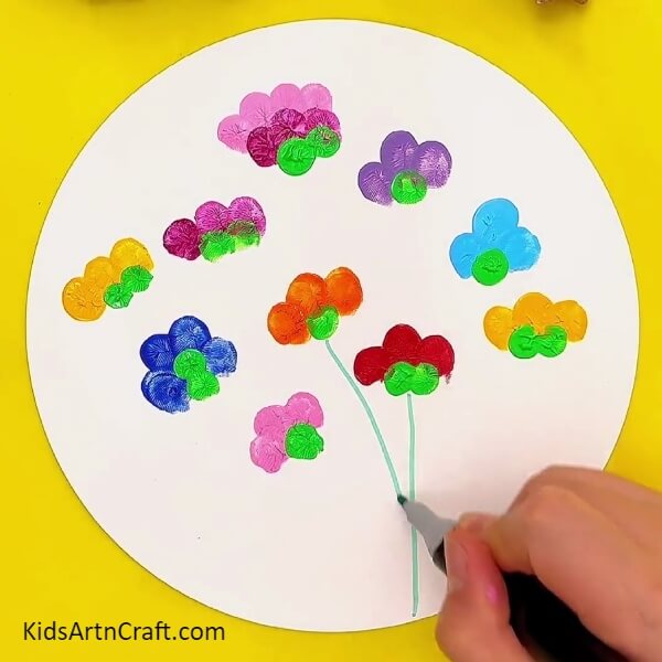 Making stems with green marker/sketch pen- A Kid-Friendly Tutorial to Create Flower Fingerprint Paintings with Color 
