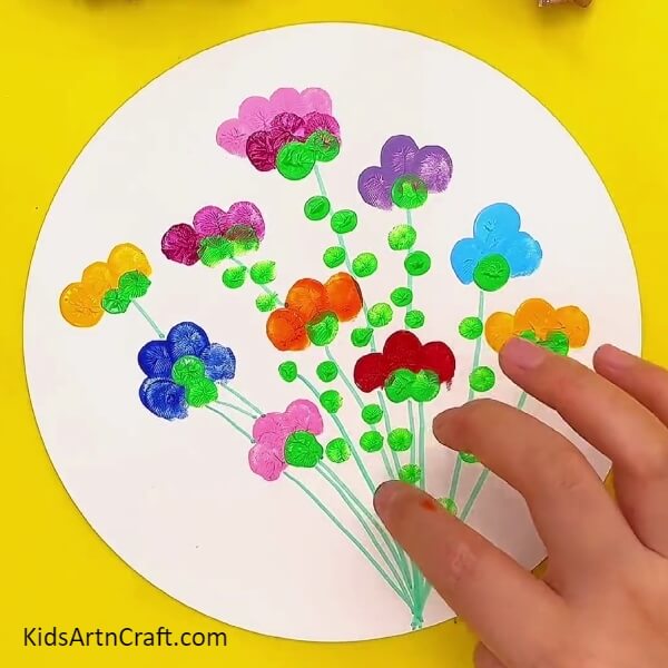 Making green prints all over the stems from green colour- A Comprehensive Guide on Crafting Colorful Flower Fingerprint Artwork with Kids 