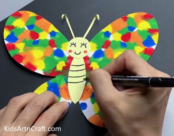 Adding Details On The Bee - Create a Paper Butterfly Craft for the Little Ones
