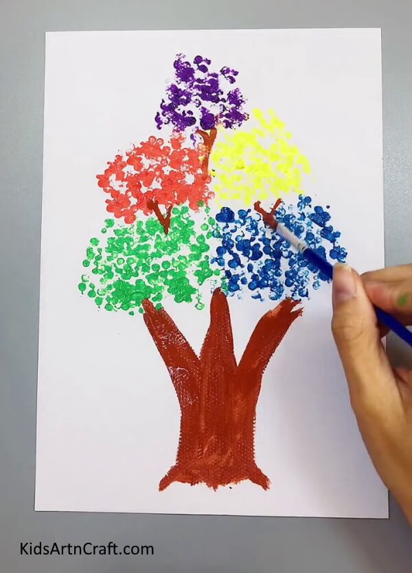 Making Branches - An artistic endeavor of creating a tree painting with earbuds and paint.