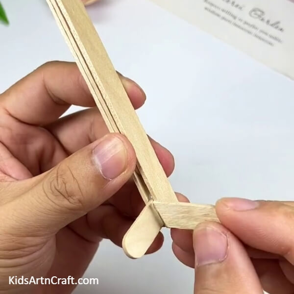 Sticking A Small Piece Of The Popsicle Stick-Create Your Own Airplane Out Of Popsicle Sticks With This Step-by-step Tutorial For Kids 