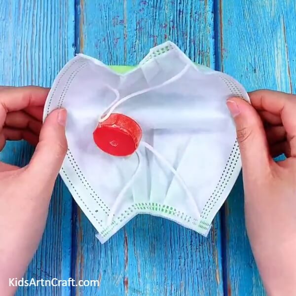 Opening Surgical Mask To Make A Hot Air Balloon- An inventive hot air balloon that has been recycled from a surgical mask and bottle cap