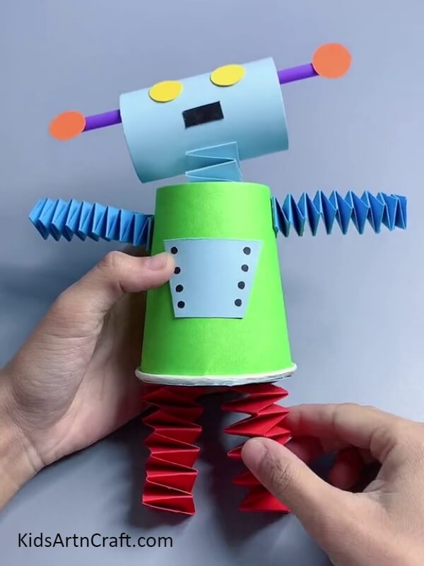 Attaching The Legs And Arms. Step-by-step Tutorial of Cool Robot Craft Using Paper Cup &amp; Toilet Paper Roll for kids
