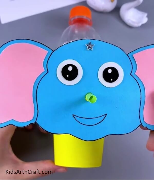 Making the elephant face- This tutorial is perfect for kids to make an elephant-shaped water dispenser from a plastic bottle.