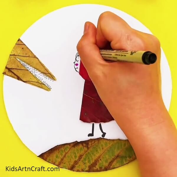 Take A Black Marker And Draw The Face And Hairs Of The Red Riding Hood-Making a Lovely Craft with Red Riding Hood and Fallen Leaves