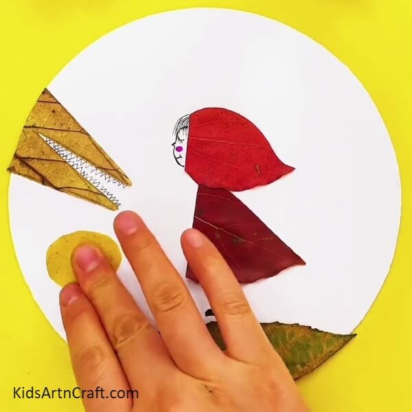 Take A Yellow Leaf Cut It Into An Oval Shape And Paste It Above The Green Leaf-Crafting a Sweet Little Red Riding Hood with Autumn Leaves
