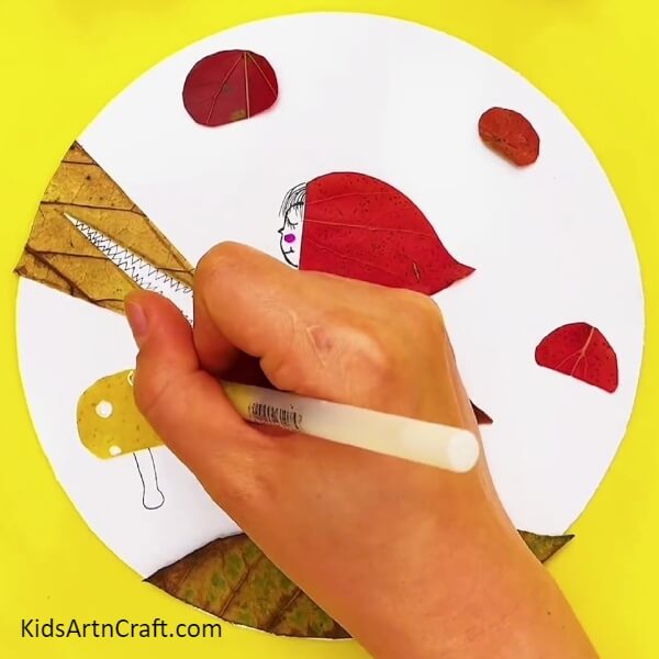Take A Black Pen And Draw An Umbrella-like Structure-Utilizing Fallen Leaves to Build a Pretty Red Riding Hood
