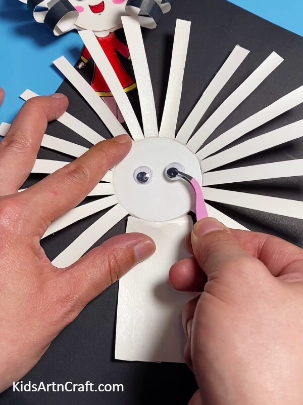 Pasting The Googly Eyes On The Back-Steps for Crafting an Adorable Doll Out of a Paper Cup 