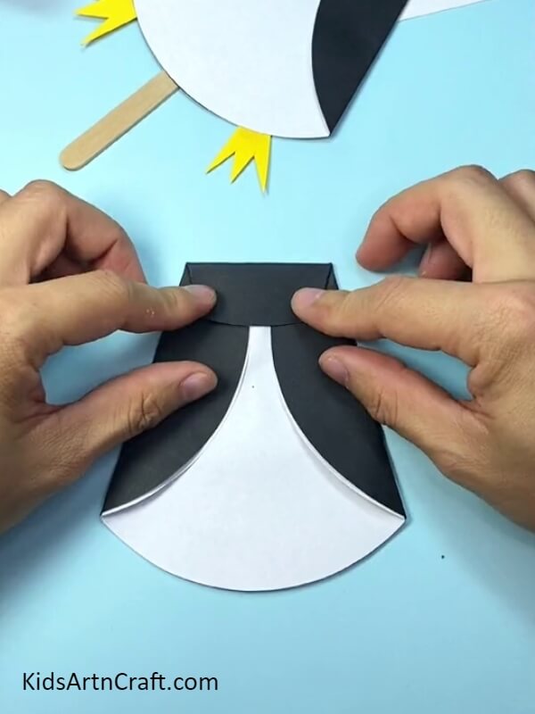 Making another fold- Darling Paper and Popsicle Stick Penguin Handicraft For Beginners