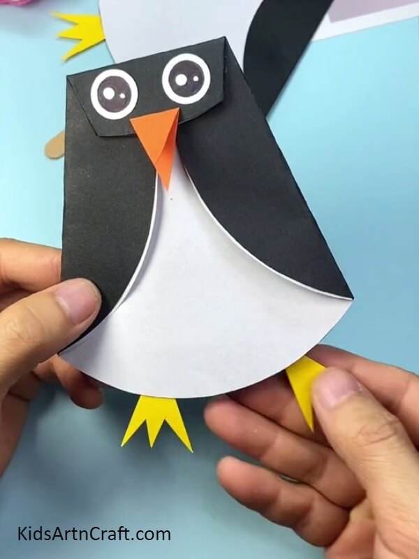 Making the feet of the penguin- Attractive Paper and Popsicle Stick Penguin Work For Freshers