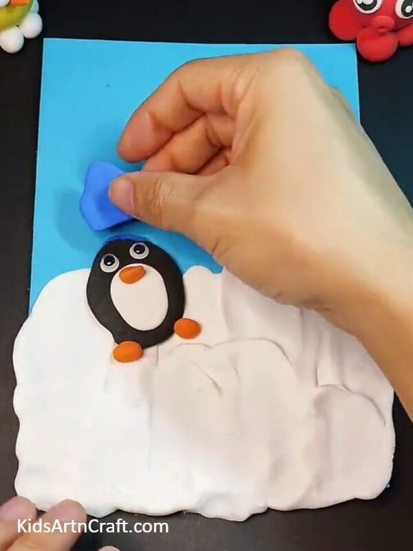 Creating woolen cap with clay- A Step-by-step Guide To Helping Kids Create Cute Penguin Clay Creations