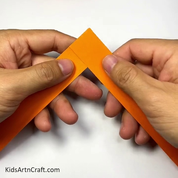 Cutting two strips form orange colour paper. Cute Tiger Craft Step-by-step Tutorial For Kids
