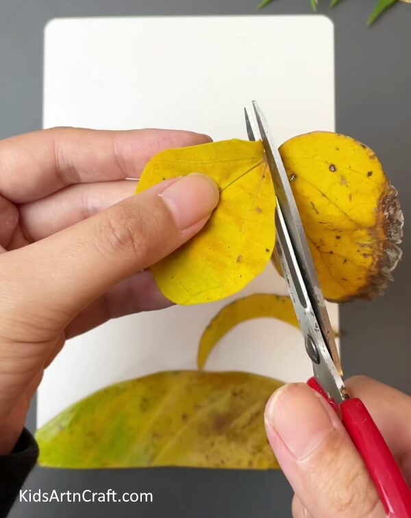 Cutting Small Yellow Leaves- Crafting a Beautiful Bird Scene with this Basic Leaf Craft for Kids 