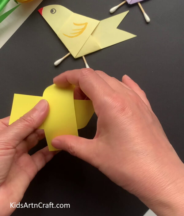 Crossing Yellow Paper Strip - A simple bird-related craft made using paper and earbuds.