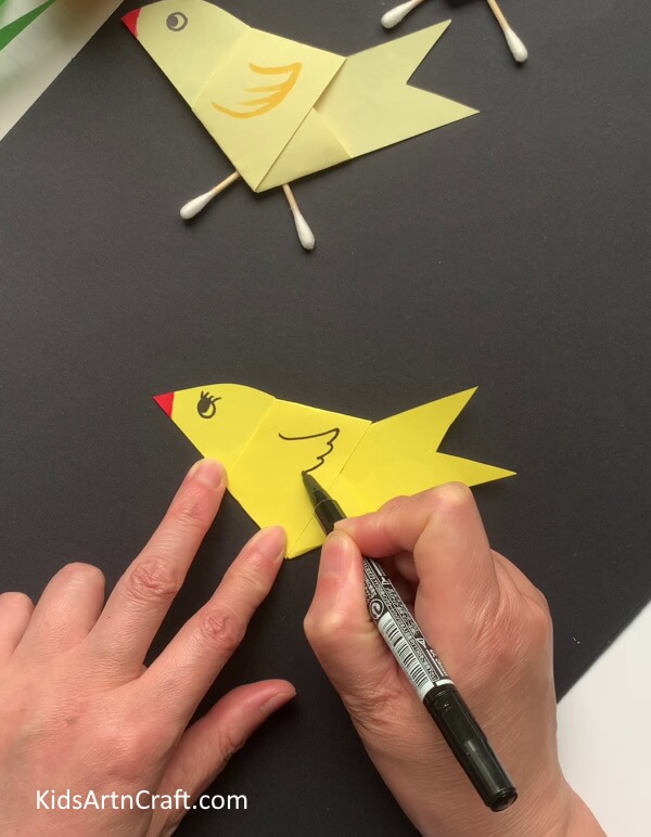 Drawing Details Using Marker - Utilizing paper and earbuds to make a bird craft.
