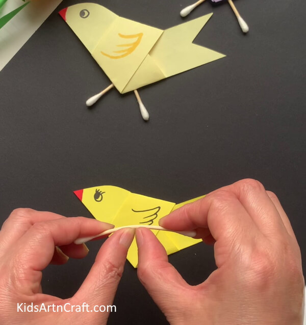 Dividing Earbud Into Two Halves - Constructing a bird-related craft using paper and earphones.