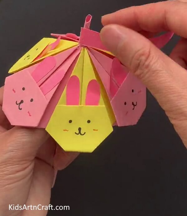 Inserting The Stick Into Umbrella Do-It-Yourself Bunny Face Paper Umbrella - An Easy to Follow Tutorial