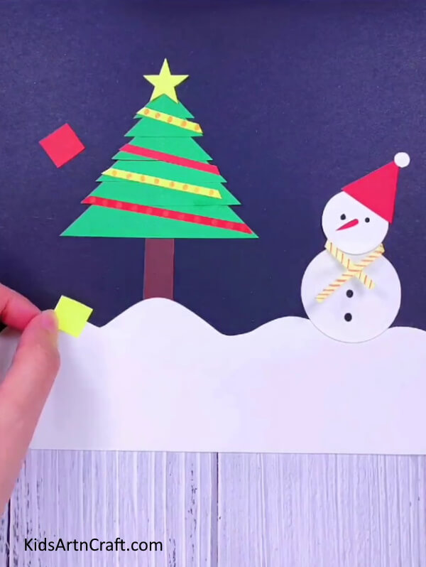 Paste squares all over the paper- Assemble a Christmas Tree with your own materials for a jolly decoration.