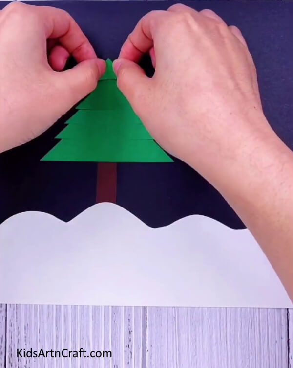 Paste all the triangular cutouts one over the other- Assemble a Christmas Tree with your own materials for a jolly decoration.