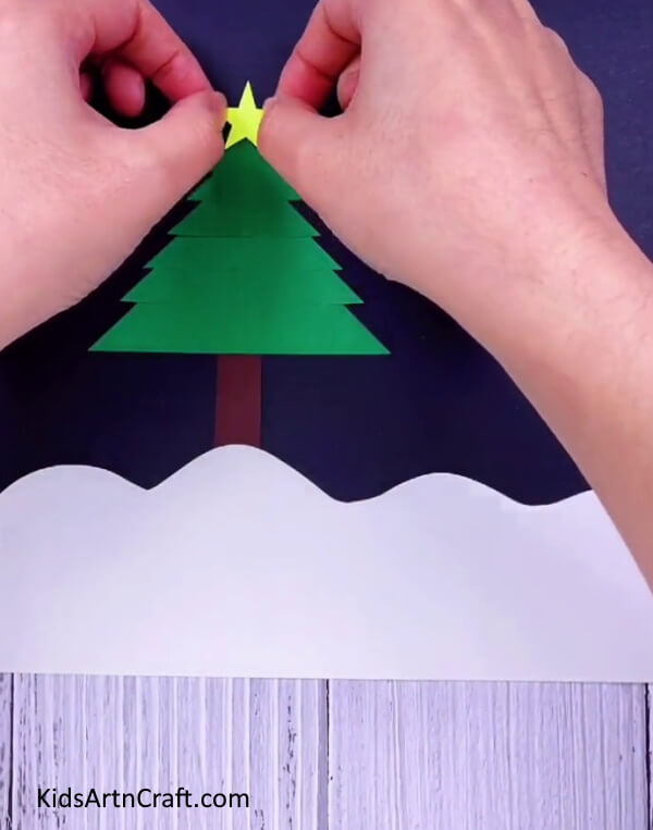 Paste a star- Construct a Christmas Tree with your own supplies for a cheerful decoration.