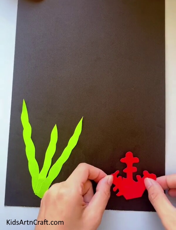 Pasting Red Coral Making a Fish Tank with Craft Paper for children