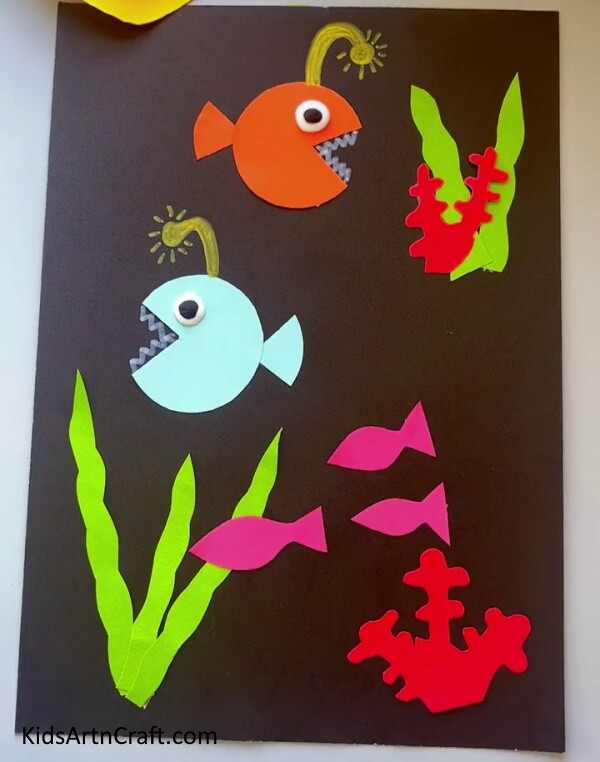 Pasting Small Fishes . Crafting a Fish Aquarium out of Craft Paper for children