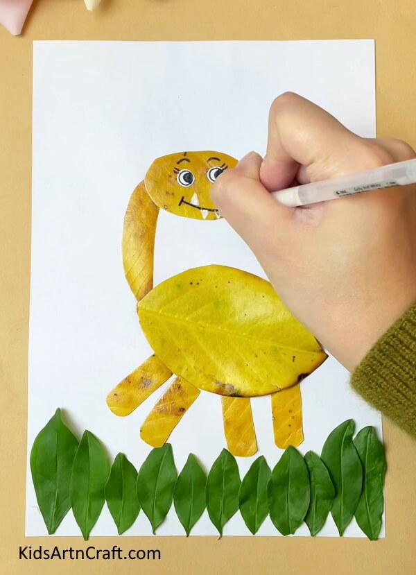 Completing the Facial Features of the Dinosaur- A Tutorial for Kids - How To Put Together a Dinosaur Animal Craft with Leaves