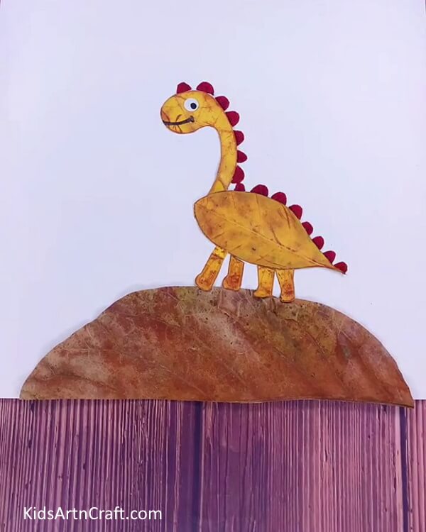 Pasting Spikes on Dinosaur's Body with Leaf - This step by step tutorial shows kids how to make a dinosaur out of leaves. 