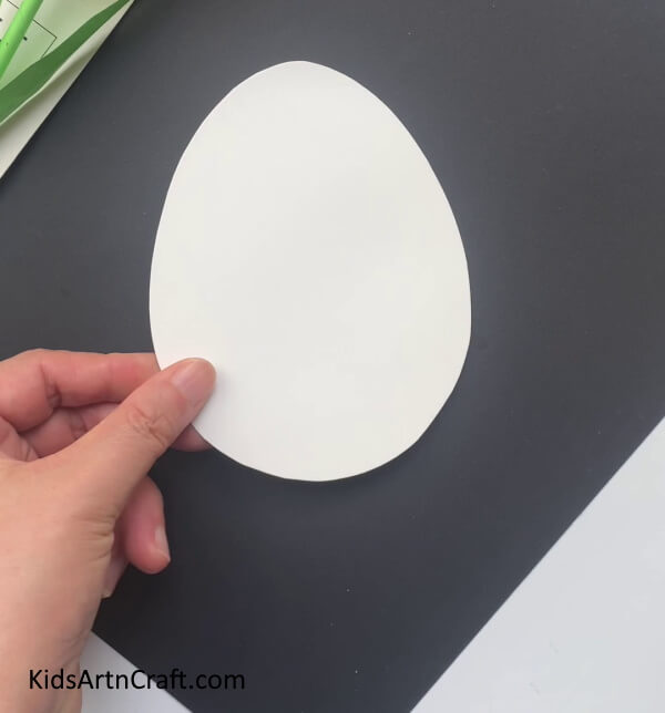 Cutting An Egg Shape Out Of White Paper - Cute Dragon Creation Constructed Within A Paper Egg
