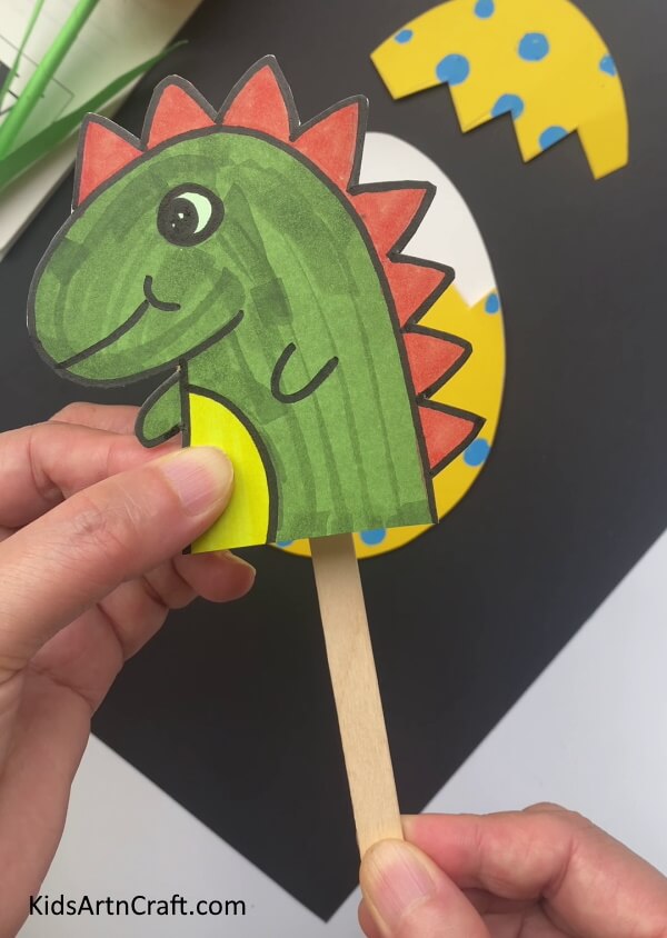 Pasting Dragon On Popsicle Stick - Fascinating Dragon Craft Constructed In A Paper Egg