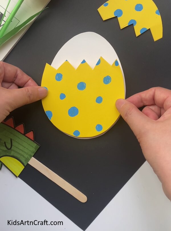 Pasting Sides Of Yellow Egg - An Enticing Dragon Creation Constructed Out of a Paper Egg
