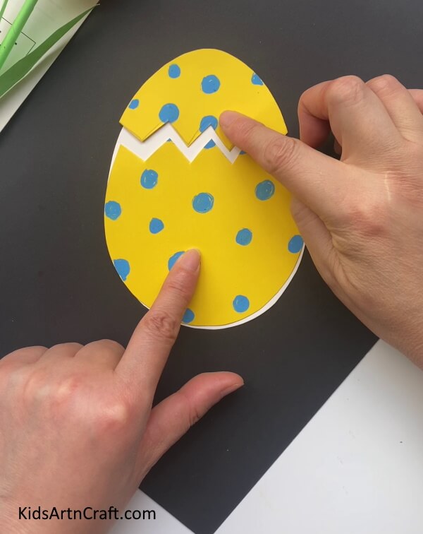 Separating the Top Part of the Yellow Egg - Charming Dragon Craft Constructed In A Paper Egg