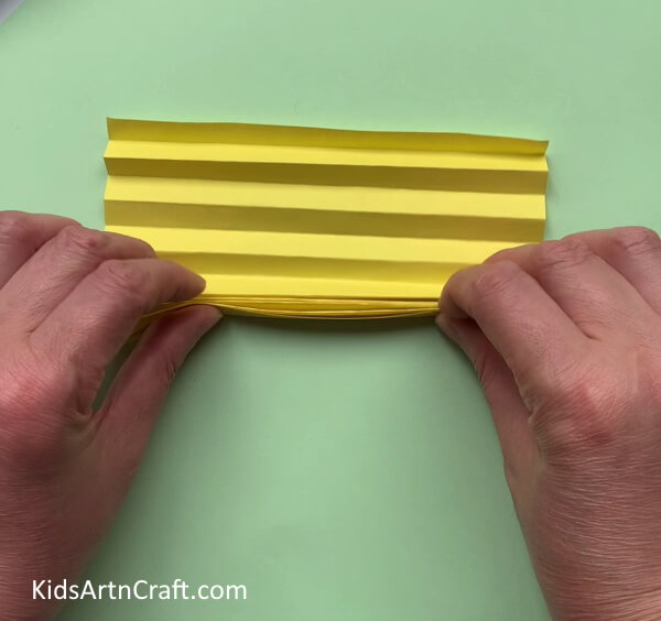 Folding The Paper Into Zigzag Strips - Construct your own simple paper bee craft with the help of your kids.