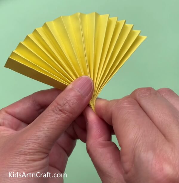 Folding The Strips Into Half - Create a simple paper bee craft with your children.