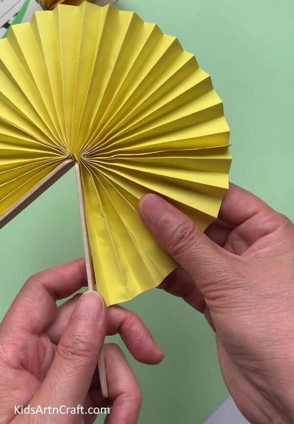 Pasting Another Ice Cream Stick - Do it yourself – make an easy paper bee craft with your kids.