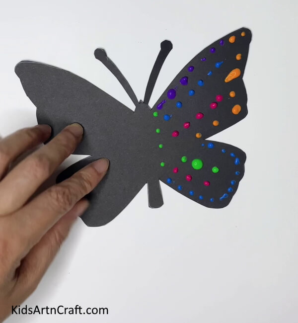 Adding More Colorful Paint Dots Making Paper Butterflies - A Kid-Friendly DIY Activity