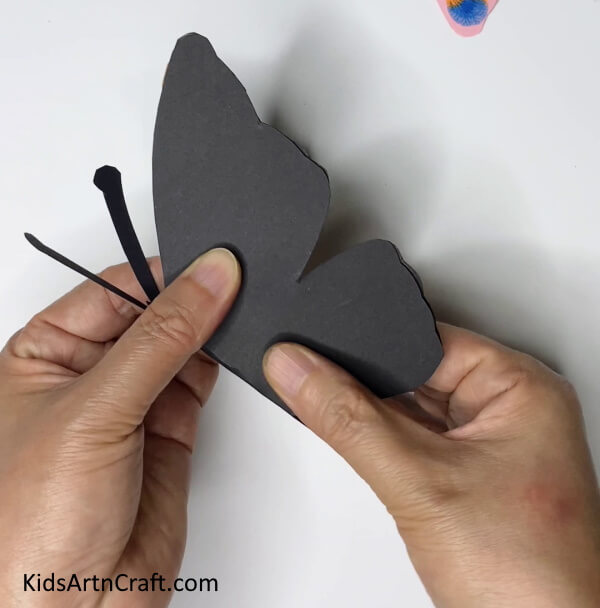 Folding The Wings Of The Butterfly DIY Paper Butterfly Art - A Fun Idea for Kids