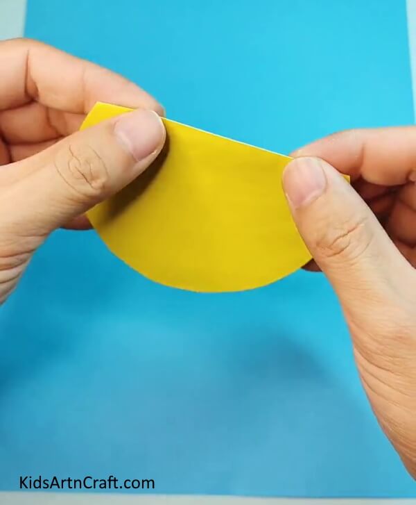 Fold the yellow craft paper- Crafting a Bird out of Paper – A Comprehensive Guide