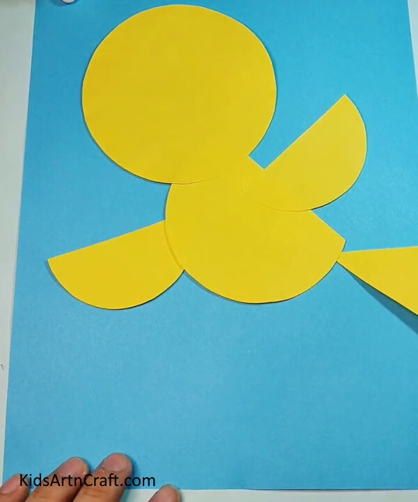 Make triangle with yellow craft paper- Create a Paper Bird with This Easy Tutorial