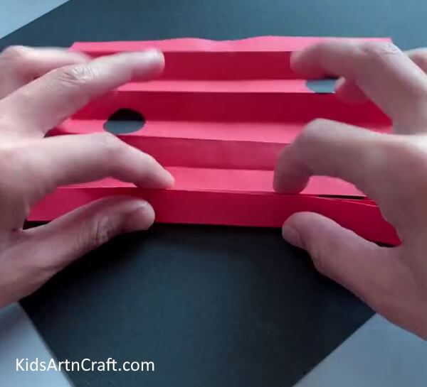Create Successive Folds On The Paper for the Ladybug Craft Tutorial for School