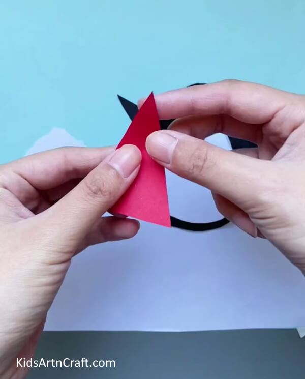 Cutting a Bigger Conical Shape-Preschoolers can easily make a paper penguin craft