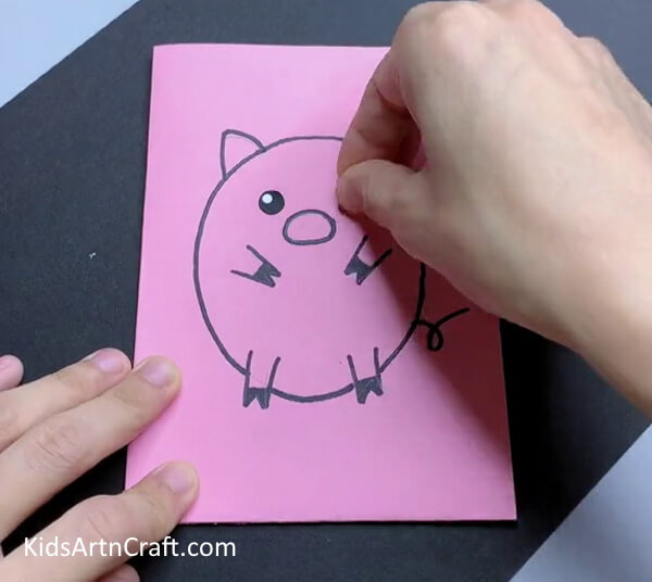 Pasting Eyes-Crafting a paper pig for little ones
