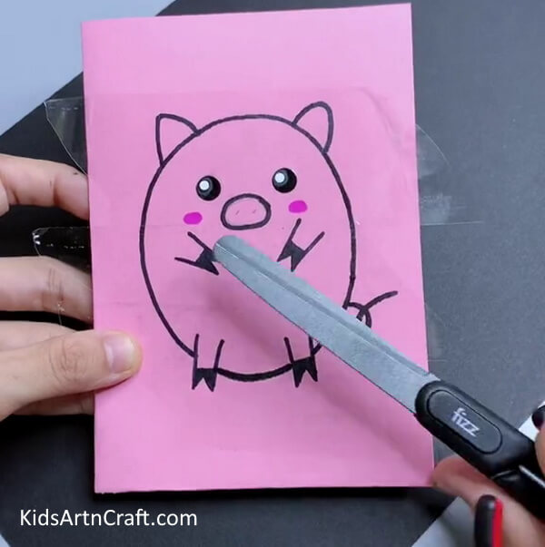 Cutting Out The Piggy-Make a paper pig craft with this simple tutorial