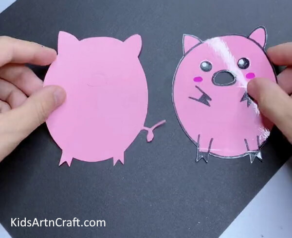 Cutting Out the Nose-Showing kids how to make a paper pig craft at home