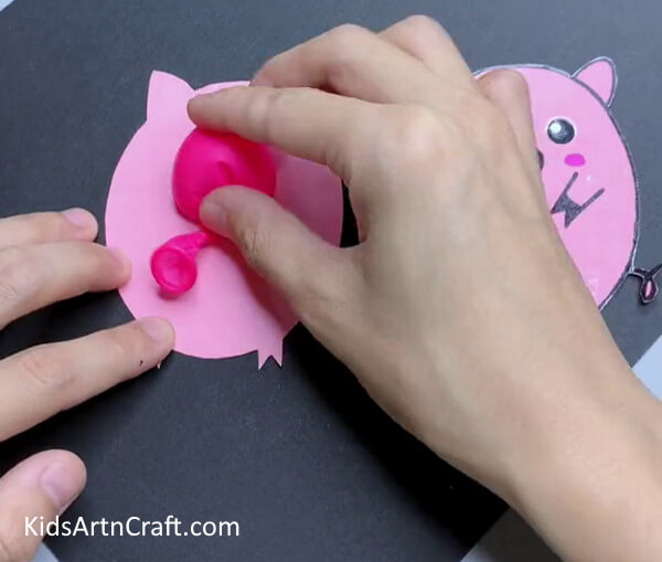 Pasting A Balloon-Step-by-step instructions for making a paper pig craft for children