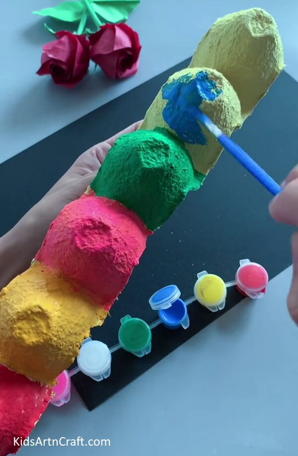 Painting The Caterpillar's Body - Learn how to make your own Caterpillar using an Egg Carton with this tutorial for children.